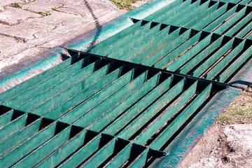 Gutters drain grate, drain cover. Road drains - sewer cover. iron grate of water drain on the road...