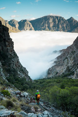 Fototapeta na wymiar A climber taking a photo while hiking into the remote mountains 