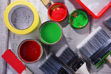 Paintbrushes of different size and paint can