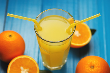 Homemade fresh orange juice on blue wooden table
