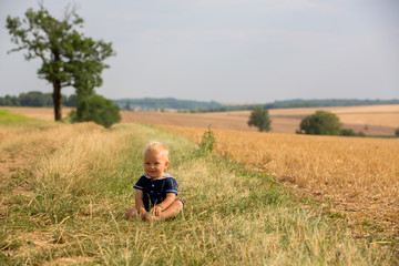 Naklejka na ściany i meble Baby boy in plain field in France