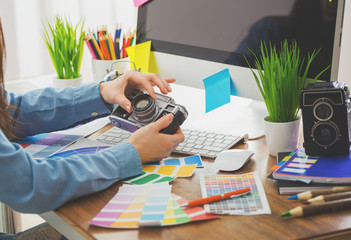 Young photographer and graphic designer at work in office