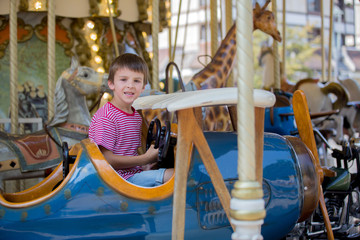 Children going on Merry Go Round, kids play on carousel