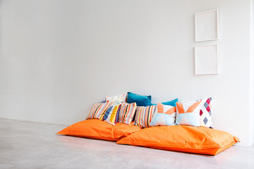 Bean bags and pillows in minimalist styled white room