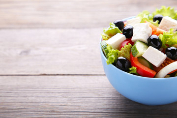 Fresh vegetable salad on grey background