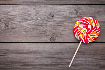 Colorful lollipop on grey wooden background, sweet candy concept