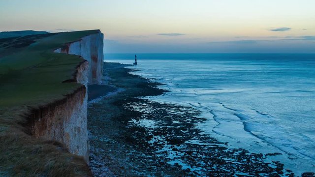 Panoramic view of Seven Sisters cliffs with lighthouse and sea on background at sunrise