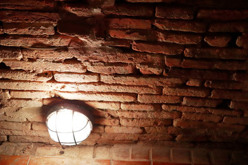 Light bulb in brick tunnel  at Wat Umong Changmai Thailand.