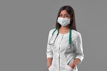 Young female doctor wearing protective mask with stethoscope