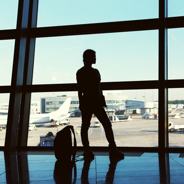 traveler at airport. silhouette of a girl with a backpack. business and travel