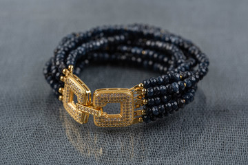 A bracelet from darkly blue sapphires with a gold fastener