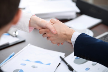 Business people shaking hands finishing up a meeting. Handshake at successful negotiation