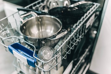 metal or glass dishes in a modern dishwasher in the kitchen