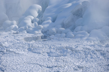 Fototapeta na wymiar Ice floes and frozen water and rocks at the bottom of Niagara Falls Ontario Canada