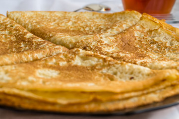 Russia, Severodvinsk, a stack of homemade Russian pancakes in the form of a triangular envelope, selective focus