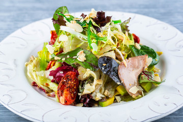 Duck and avocado warm Salad, is served with vegetables and lettuce leaves