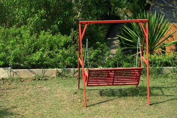 Fototapeta na wymiar Bench swing in garden