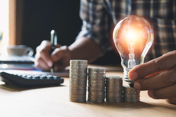 Hand of male holding a light bulb and copy space for accounting, ideas and creative concept.