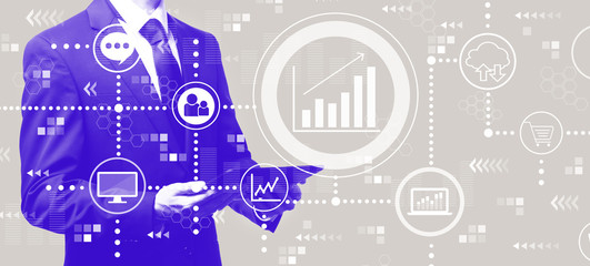 Obraz premium Marketing concept with businessman holding a tablet computer