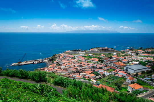The village of Corvo on the island of Corvo in the Atlantic ocean. Flores island of the Azores in the background.