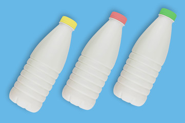 Fresh dairy product in three full plastic bottles for milk, kefir or yoghurt with red and yellow and green caps in center of blue table on kitchen. Top view. Cooking concept