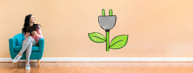 Eco plug with young woman holding a tablet computer in a chair