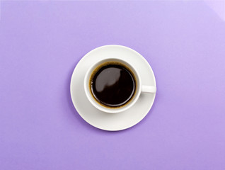A coffee cup on a purple paper background