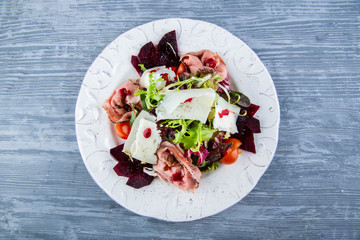 Goat cheese roast beef salad, is served in cowberry sauce