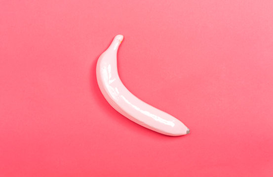 Funky painted banana on a pink paper background