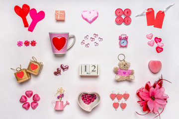 Set of feminine accessories in red and pink colors on white background. Love collection, decorative items, souvenirs. Calendar date May 12, greeting card for mother's day in 2019. Flat lay, top view