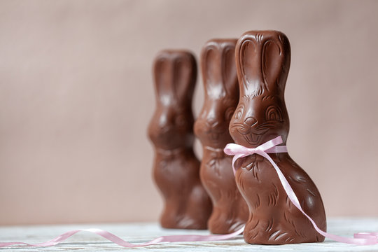 Chocolate easter bunny on pink background, easter concept background.