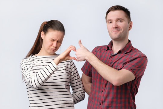 Friends aman and woman making friendzone symbol