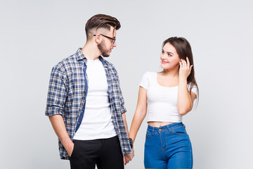 Couple of two lovely person wearing at casual style. Holding arms. White background.