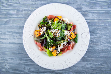 Fresh vegetables with bacon, cheese and sesame in sauce