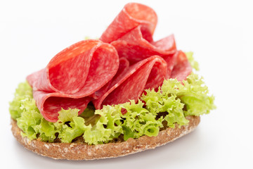 Sandwich with salami sausage on white background.