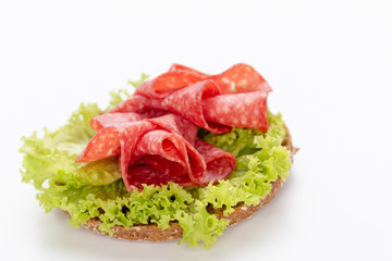 Sandwich with salami sausage on white background.