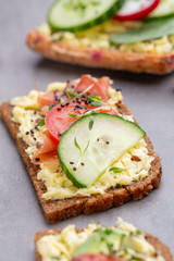 Sandwiches with cream cheese, vegetables and salami.