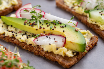 Sandwiches with cream cheese, vegetables and salami.
