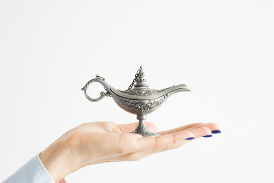 Business Woman Holding Genie Lamp Waiting For A Miracle