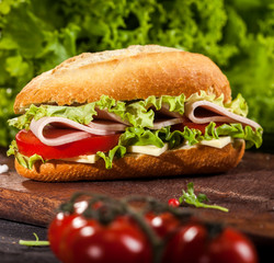 Fresh burgers on wooden table and dark background