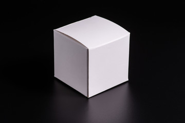 white cardboard box on black background, moke up