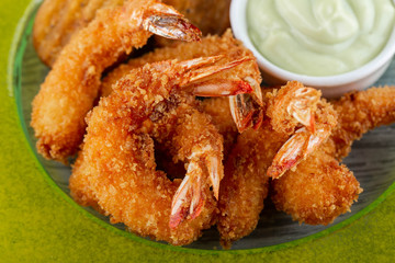 The shrimps fried on a grill with wasabi sauce