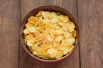 delicious corn flakes on wooden background