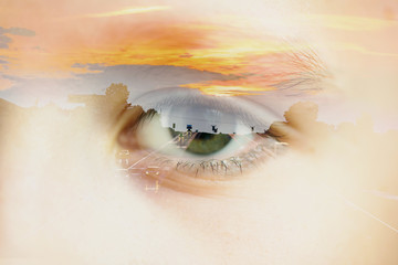 Double exposure of the closeup boy eye and highway with sunset on the horizon