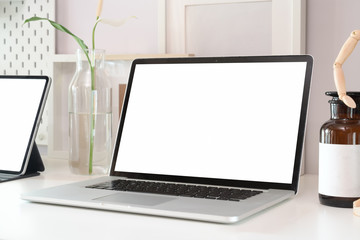 Fototapeta premium Stylish workspace with blank screen laptop computer and office supplies