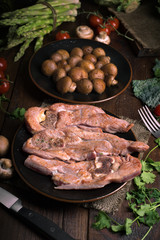 roasted turkey fillets mushrooms and other vegetables, on classic wooden board
