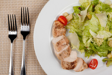 Stewed chicken fillet with tomato and cabbage salad.