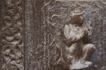 Archaeological, Close Up of carved art figures on old wood carvings on the wall temple at Shwe Nan Daw Kyaung (Golden Palace Monastery) in Mandalay, Myanmar