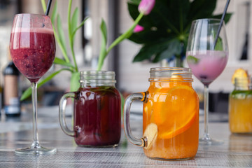 Food shooting. Berry cocktail in crystal glass decorated mint, berries, pomegranate, orange, pineapple. Concept summer drinks, fresh, milkshake, smoothies, lemonade, soft drinks, alcoholic cocktails
