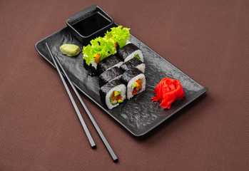 sushi on a black plate